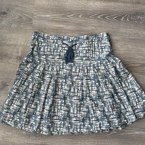 Flowing skirt with delicate ribbon detail.